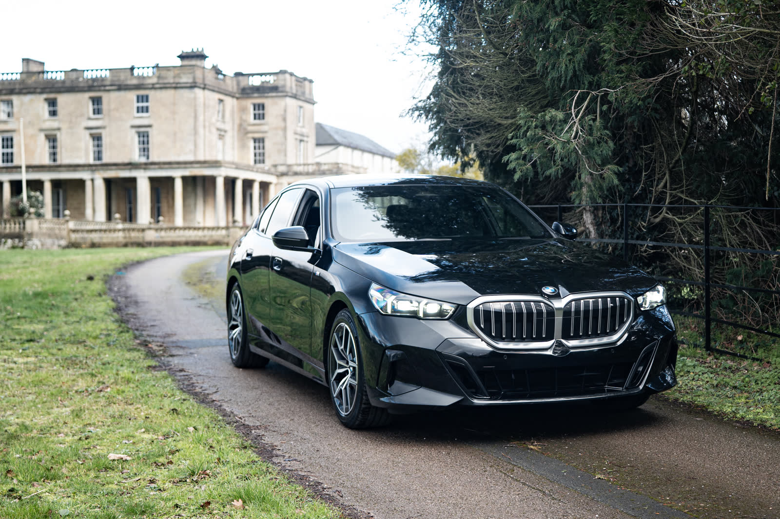 Black BMW 5 Series M Sport outside a manor house, Avant Drive hire fleet