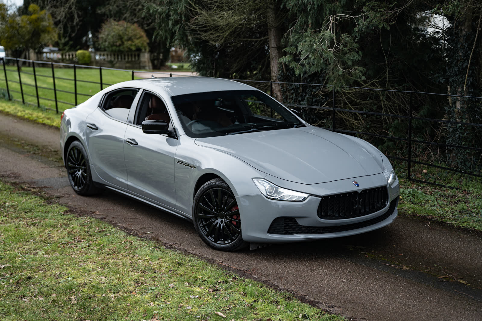 Grey Maserati Ghibli front three-quarter on a country lane