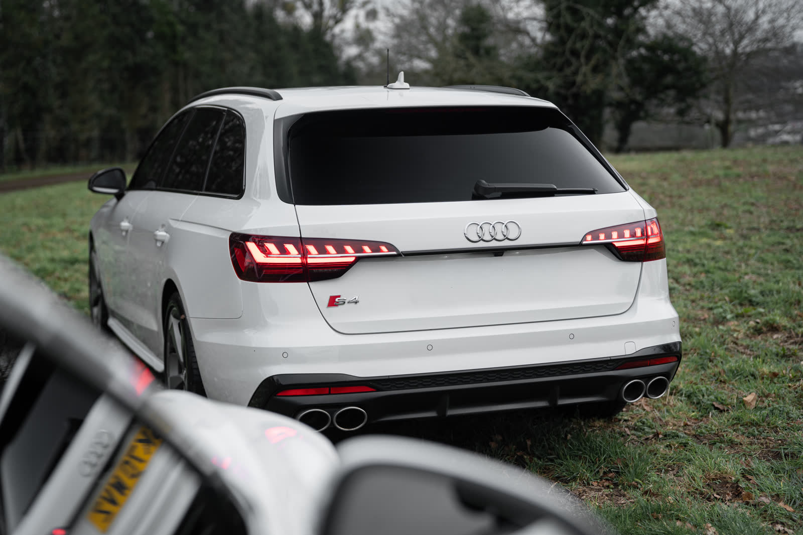 White Audi S4 Avant rear with quad exhausts in the countryside
